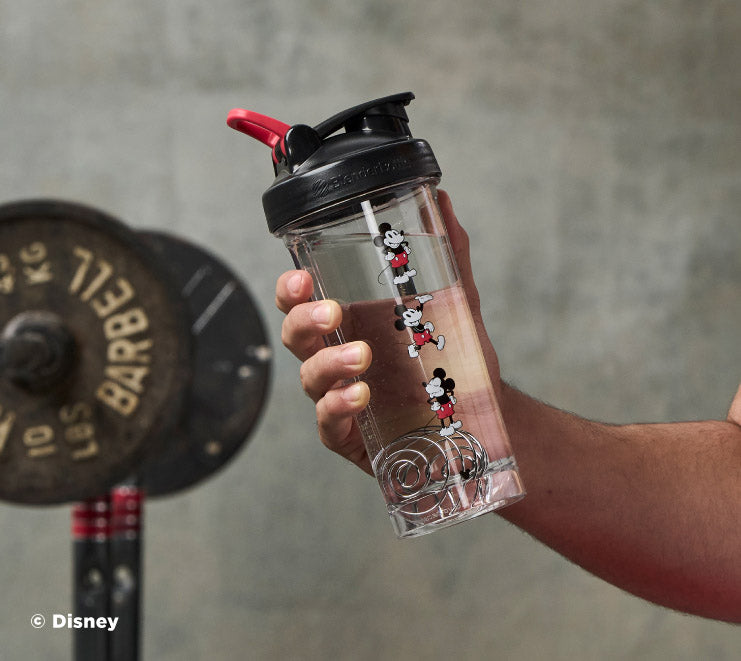 pro-series-m2 Mickey_Mouse_Protein_Shaker_Bottle_Being_Held_In_the_Gym.jpg